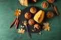 Composition with tasty muffins, cut pumpkin and cinnamon on color table Royalty Free Stock Photo
