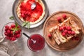 Composition with tasty thin pancakes, berries and jam on light table Royalty Free Stock Photo