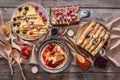 Composition with tasty thin pancakes, berries and jam on wooden table Royalty Free Stock Photo