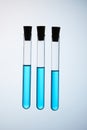 Composition of test tubes filled with blue liquid floating in air Royalty Free Stock Photo