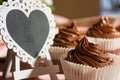 Composition of Three Chocolate Cup Cakes and a Heart-Shaped Blackboard Royalty Free Stock Photo