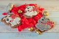 Composition of three gingerbread cookies in shape of dogs and christmas decorations on table