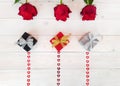 Composition of three red roses, handmade gift box, bows, sequins hearts on wooden table. Content for Birthday, Valentines Day, Royalty Free Stock Photo