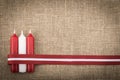 Composition of three red white candles and latvian flag ribbon Royalty Free Stock Photo