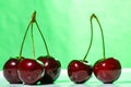 Composition of three and two ripe sweet cherries Royalty Free Stock Photo