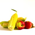 Unpeeled corn cobs and red apples isolated on white background Royalty Free Stock Photo