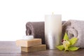 Composition with towels, candle and soap bars on table against white background Royalty Free Stock Photo