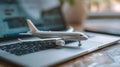 Composition with toy plane and laptop on table. Travel and information Concept. Mini airplane toy model. Royalty Free Stock Photo