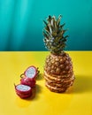Tropical Pineapple fruit single whole and dragon fruit, pitaya made up of sliceson on a duotone yellow-green background