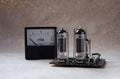 Composition of tube amplifier and vintage ammeter. electronic background.