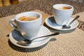 Composition, two white coffee cups, serving plates, small metal