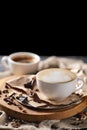 Composition with two glass of cappuccino and served with coffee beans and chocolate on wooden chopping board Royalty Free Stock Photo