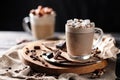 Composition with two glass of cappuccino topped with marshmallow and served with coffee beans and chocolate Royalty Free Stock Photo