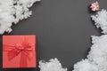 Composition with two red gift boxes of different sizes and a white fiberfill between them Royalty Free Stock Photo