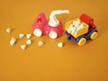 A composition of two toy cars, in the back are vitamin tablets in the shape of hearts, sweet tablets are scattered on a bright ba Royalty Free Stock Photo