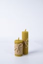 Composition of two wax candles tied with twine on a white background. natural beeswax. handmade candles