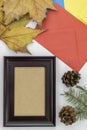 Composition Using Autumn Leaves, Empty Picture Frame, Colorful Envelopes, and Two Pine Cones Royalty Free Stock Photo