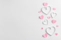 Composition for Valentine`s Day February 14th. Delicate composition of pink hearts made of paper on a white background Royalty Free Stock Photo