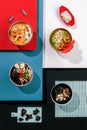 Composition with variety of Asian soup on colorful background, seafood , tom yum, ramen, cream soup with spinach and shrimps , Royalty Free Stock Photo