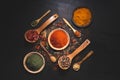 Composition with variety of spices and herbs on black background top view. Cooking ingredients and condiments concept Royalty Free Stock Photo