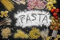 composition with various types of Italian pasta, with flour and wheat and the word pasta written Royalty Free Stock Photo