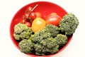 Composition of vegetables in bowl. Broccoli, red and yellow tomatoes Royalty Free Stock Photo