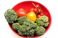 Composition of vegetables in bowl. Broccoli, red and yellow tomatoes Royalty Free Stock Photo