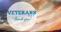 Composition of veterans day thank you text, over american flag and sunset sky Royalty Free Stock Photo