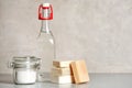 Composition with vinegar, baking soda and soap bars for cleaning on table Royalty Free Stock Photo