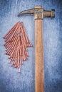 Composition of vintage claw hammer copper construction nails on Royalty Free Stock Photo