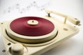 Composition with vintage red record player and musical notes Royalty Free Stock Photo