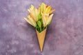 Composition wafer cone flowers and lily on a beautiful purple abstract background. Creative composition. Orange lily. Flat lay.