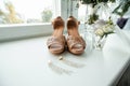 Composition - wedding shoes with decor and accessories. The concept of marriage, family relationships, wedding paraphernalia Royalty Free Stock Photo