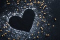 Composition with wheat grains, flour with heart shape on black background Royalty Free Stock Photo