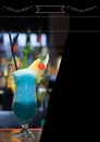 Composition of white frame over blue drink in bar on black background Royalty Free Stock Photo