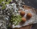 composition of white and green spring flowers, selective focus. in the background baking muffins on a wooden board. The Royalty Free Stock Photo