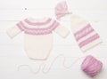 Composition of white-pink knitted suit and hat Royalty Free Stock Photo