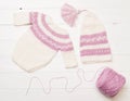 Composition of white-pink knitted suit and hat Royalty Free Stock Photo