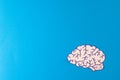 Composition of white and purple brain on blue background with copy space