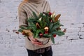 Xmas composition in wicker basket in hands Royalty Free Stock Photo