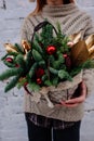 Xmas composition in wicker basket in hands Royalty Free Stock Photo