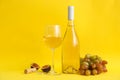 Composition wine and fruits on yellow background