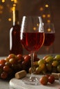 Composition wine and grape on brown background with blurred lights