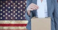 Composition of woman casting vote into ballot box against american flag Royalty Free Stock Photo