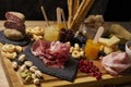 Wooden cutting board with cold cuts and cheeses Royalty Free Stock Photo