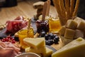 Wooden cutting board with cold cuts and cheeses Royalty Free Stock Photo