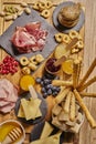 Wooden cutting board with cold cuts and cheeses Royalty Free Stock Photo