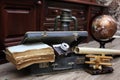 Composition on a wooden floor vintage globe with old leather sui Royalty Free Stock Photo