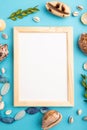 Composition with wooden frame, seashells, green boxwood. mockup on blue pastel background. top view, copy space