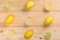 Composition on a wooden light background of lobules and whole lemons
